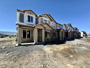 Property under construction with stone siding