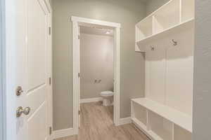 Mudroom featuring baseboards and light wood-style flooring