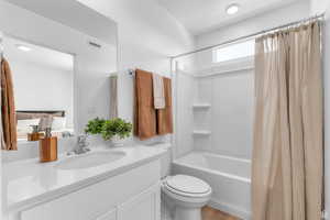 Bathroom featuring shower / tub combo with curtain and vanity