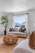 Living room with a mountain view, wood finished floors, and a textured ceiling