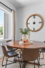 Dining space featuring light wood finished floors and baseboards