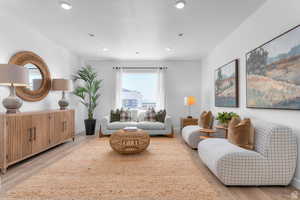Living area featuring light wood-type flooring and recessed lighting