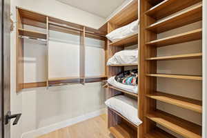 Spacious closet with light wood-style floors