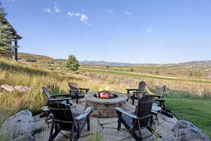 View of patio / terrace with a mountain view and a rural view