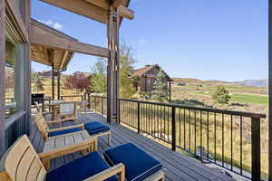 Deck featuring outdoor dining area and a mountain view