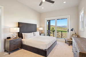 Bedroom with light colored carpet, access to exterior, a ceiling fan, recessed lighting, and a mountain view