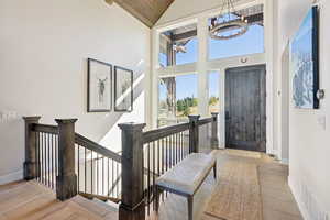 Entryway featuring a chandelier, high vaulted ceiling, and wood ceiling