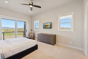 Bedroom with carpet flooring, access to outside, ceiling fan, recessed lighting, and a mountain view