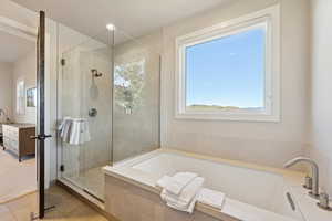 Bathroom with a shower stall, connected bathroom, a garden tub, and light tile patterned floors