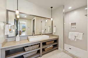 Full bathroom with a stall shower, light tile patterned floors, recessed lighting, and vanity
