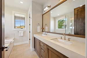 Full bathroom featuring double vanity, a garden tub, light tile patterned floors, recessed lighting, and a shower stall