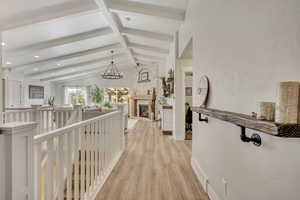 Corridor featuring an upstairs landing, light wood finished floors, a chandelier, and recessed lighting