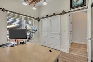 Office space with arched walkways and light wood-style floors