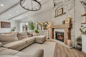 Living area with wood finished floors, recessed lighting, and a fireplace