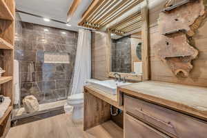 Bathroom with a shower stall, vanity, and light wood-type flooring