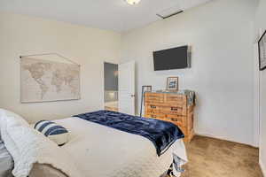 Carpeted bedroom featuring baseboards