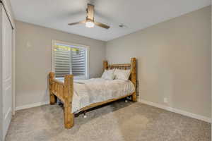 Bedroom with carpet flooring and a ceiling fan