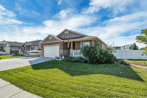 Craftsman-style home with stone siding, concrete driveway, an attached garage, a porch, and board and batten siding