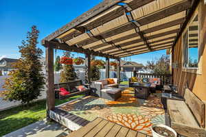Wooden terrace with a fenced backyard and outdoor lounge area