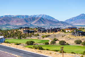 View of mountain background featuring a golf course