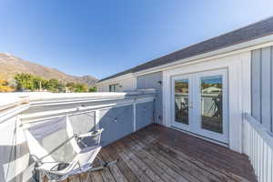 Wooden deck with a mountain view and french doors