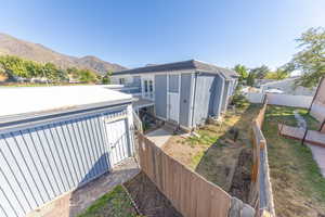 View of home's exterior featuring a fenced backyard, garage, and a mountain view.