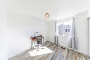 Bedroom featuring light wood finished floors and baseboards