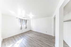 Bedroom with light wood-style flooring and baseboards. Large Double closet.