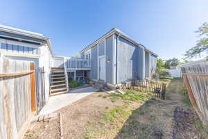 Entrance to the house with a fenced backyard and entry steps