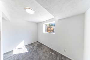 Bedroom featuring dark carpet. (Carpet/flooring allowance provided).
