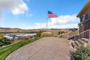 View of patio with stairs and a mountain view