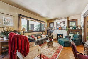 Living area featuring wood finished floors and a fireplace