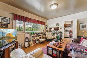 Living room with wood finished floors and crown molding