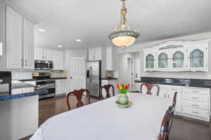 Dining area featuring recessed lighting and dark wood-style floors