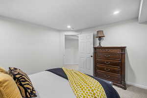 Bedroom with light carpet and recessed lighting