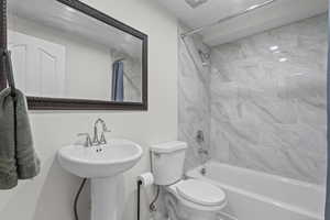 Bathroom featuring shower / bath combo with shower curtain and toilet