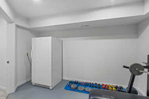 Workout area with baseboards and finished concrete floors