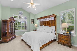 Bedroom with vaulted ceiling, carpet floors, ceiling fan, and recessed lighting