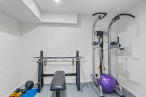 Exercise area with baseboards and recessed lighting