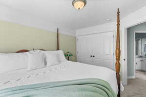 Bedroom featuring carpet and a closet