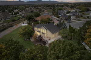 Aerial view of property and surrounding area with nearby suburban area and mountains
