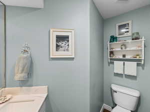 Half bathroom featuring vanity and toilet