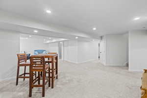 Dining room featuring light colored carpet and recessed lighting