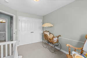 Carpeted bedroom featuring a closet and baseboards