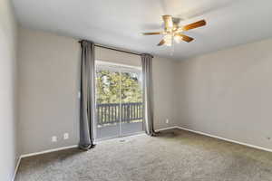 Spare room with carpet flooring and a ceiling fan