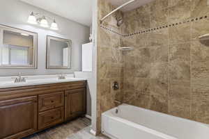 Full bathroom with shower / tub combination, double vanity, and LVP Flooring