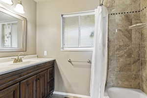 Full bath featuring vanity and shower