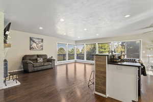 Living area featuring LVP Flooring, recessed lighting, and a fireplace