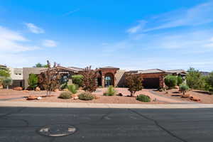 View of front of house featuring stucco siding, concrete driveway, stone siding, and a tile roof