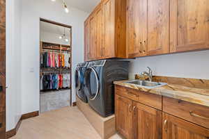 Laundry area with cabinet space and washer and dryer